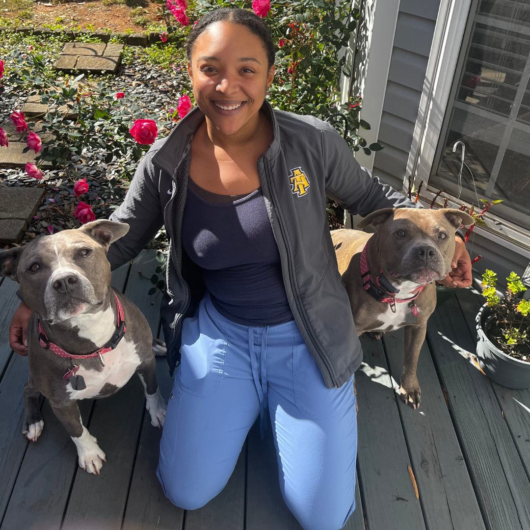 D'yana with a happy groomed client pup outdoors
